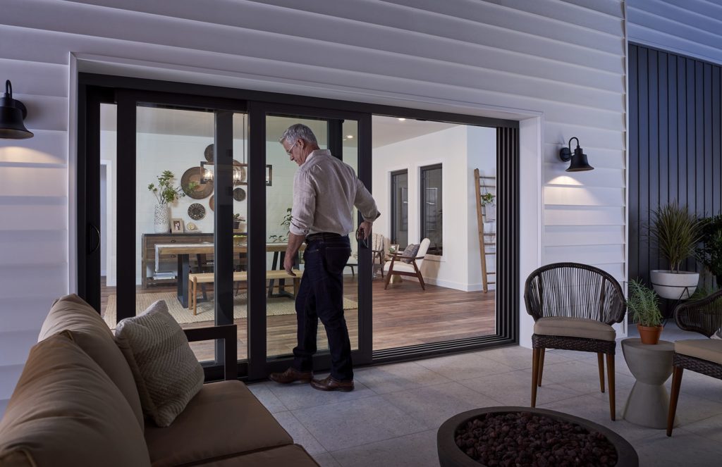 Man entering house through sliding patio door