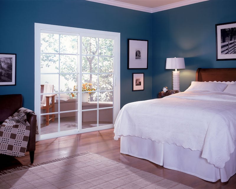 French Rail Door in a bedroom that opens up to a backyard patio